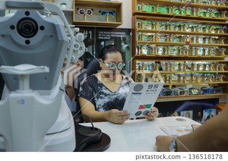 Phoropter for eye test, lenses glasses for eye check in optical store. Phoropter for eye test, lenses glasses for eye check in optical store. 136518178
