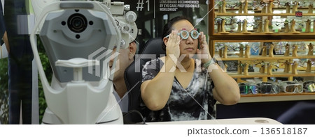 Phoropter for eye test, lenses glasses for eye check in optical store. 136518187