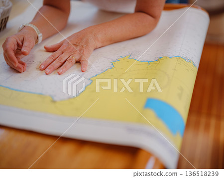 Woman Sailor Studying Navigation Map Inside Yacht Cabin Interior Woman Sailor Studying Navigation Map Inside Yacht Cabin Interior 136518239