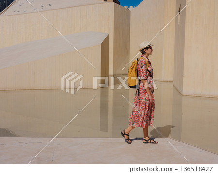Young female tourist exploring iconic landmarks of the United Arab Emirates. 136518427