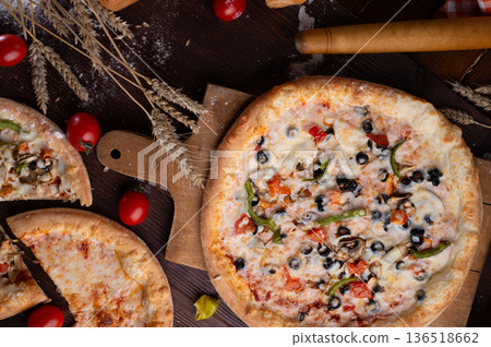 tasty fresh  Pizza served at  wooden table with cherry tomatos and wheat ears.  flat lay. 136518662
