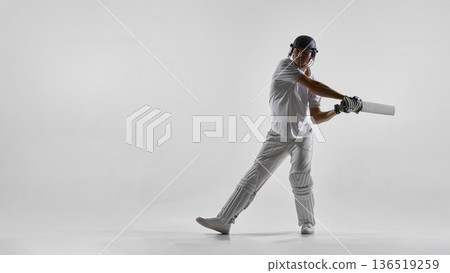 Cricket batsman executing front foot shot isolated on white background 136519259