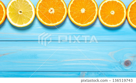 Citrus slices on a blue wooden background minimal summer concept Citrus slices on a blue wooden background minimal summer concept 136519743
