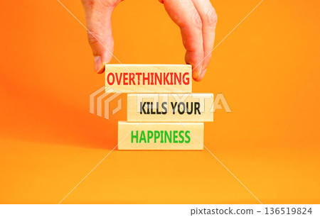 Overthinking kills your happiness symbol. Concept words Overthinking kills your happiness on wooden blocks. Beautiful orange background. Business overthinking kills happiness concept. Copy space. 136519824