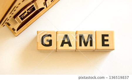 Game symbol. Concept word Game on beautiful wooden blocks. Beautiful wooden house. Beautiful white table white background. Business, lifestyle and game concept. Copy space. Game symbol. Concept word Game on beautiful wooden blocks. Beautiful wooden house. Beautiful white table white background. Business, lifestyle and game concept. Copy space. 136519837