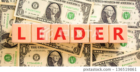 Leadership and leader symbol. Concept word Leader on beautiful wooden blocks. Beautiful dollar bills background. Beautiful dollar bills. Business leader and leadership concept. Copy space. Leadership and leader symbol. Concept word Leader on beautiful wooden blocks. Beautiful dollar bills background. Beautiful dollar bills. Business leader and leadership concept. Copy space. 136519861