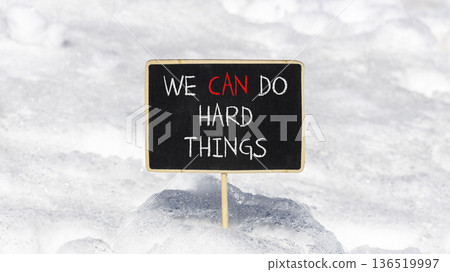 Support, help we can do hard things symbol. Concept words We can do hard things on beautiful blackboard. Beautiful white snow background. Business we can do hard things concept. Copy space. 136519997