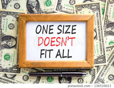 One size does not fit all symbol. Concept words One size does not fit all on beautiful wooden picture frame. Beautiful dollar bills background. Business one size does not fit all concept. Copy space. 136520021