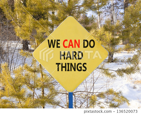 Support, help we can do hard things symbol. Concept words We can do hard things on beautiful yellow road sign. Beautiful winter forest background. Business we can do hard things concept. Copy space. Support, help we can do hard things symbol. Concept words We can do hard things on beautiful yellow road sign. Beautiful winter forest background. Business we can do hard things concept. Copy space. 136520073