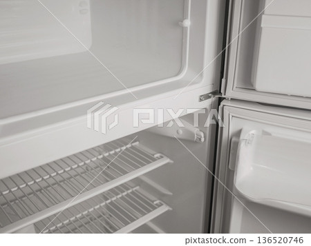Empty refrigerator and freezer interior with open door, white shelves and storage compartments. Clean modern kitchen appliance, cold storage concept with copy space Empty refrigerator and freezer interior with open door, white shelves and storage compartments. Clean modern kitchen appliance, cold storage concept with copy space 136520746