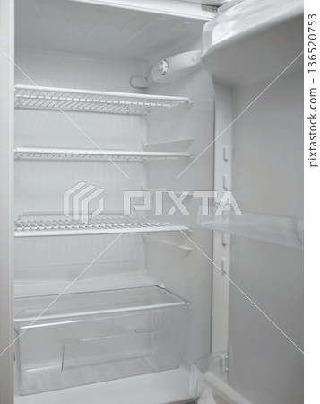 Empty clean refrigerator interior with white shelves and drawers. Minimal kitchen appliance concept, food storage space, cold storage, household technology and modern domestic lifestyle theme Empty clean refrigerator interior with white shelves and drawers. Minimal kitchen appliance concept, food storage space, cold storage, household technology and modern domestic lifestyle theme 136520753