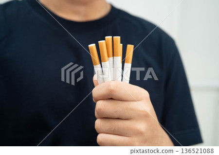 Man holding cigarette, no smoking. Man holding cigarette, no smoking. 136521088