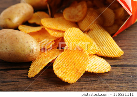 Potato chips , delicious BBQ seasoning spicy for crips, thin slice deep fried snack fast food. Potato chips , delicious BBQ seasoning spicy for crips, thin slice deep fried snack fast food. 136521111