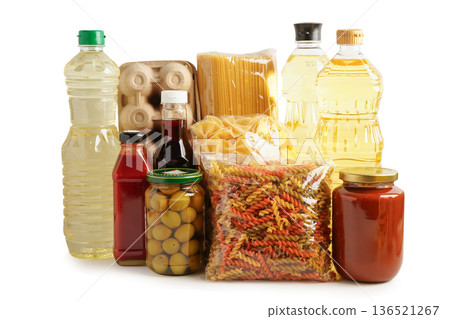 Foodstuffs in donation box isolated on white background. Foodstuffs in donation box isolated on white background. 136521267