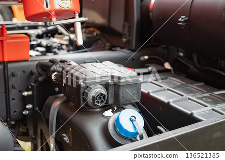 Close-up of a truck air filter housing and exhaust pipe on industrial machine. Close-up of a truck air filter housing and exhaust pipe on industrial machine. 136521385
