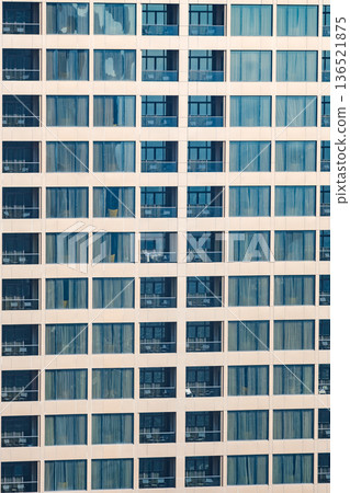 windows and balconies in a multi-storey building 136521875