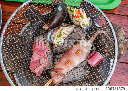 meat and seafood are baked on a grill, top view meat and seafood are baked on a grill, top view 136521879