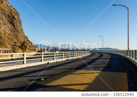 The viaduct over the sea at Okuzure Coast and Mount Fuji over Suruga Bay, shining on a clear winter day 136522040