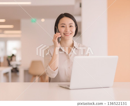 Business woman talking on a smartphone in the office 136522131