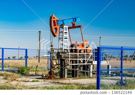 swinging oil pump in the field swinging oil pump in the field 136522149