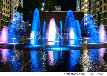 fountain jets illuminated at night, blurred fountain jets illuminated at night, blurred 136522500