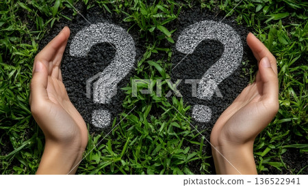 Two chalk drawn question marks between protecting hands on grass background, concept of uncertainty and seeking answers Two chalk drawn question marks between protecting hands on grass background, concept of uncertainty and seeking answers 136522941