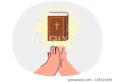 Bible with rays of light near hands of praying man who professes christian religion Bible with rays of light near hands of praying man who professes christian religion 136523045
