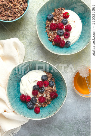 Breakfast, two bowls, yogurt, muesli with berries, and honey, homemade, no people, 136523063