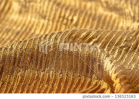 A close-up shot of gold sequin fabric for backgrounds or design elements A close-up shot of gold sequin fabric for backgrounds or design elements 136523163