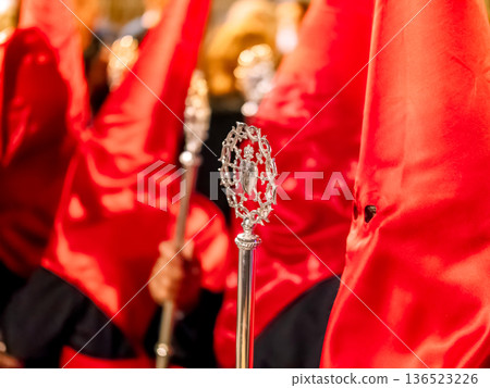 Close-up of red-hooded nazarenos with a silver scepter Close-up of red-hooded nazarenos with a silver scepter 136523226