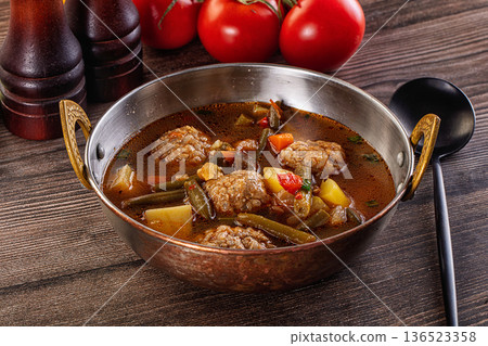 Tomato Soup with meatballs and vegetables 136523358