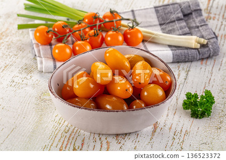 Marinated yellow cherry tomatoes heap 136523372