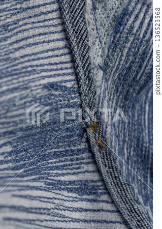 old blue jeans after they are torn, patching with a lot of threads after repairing jeans with a lot of scuff old blue jeans after they are torn, patching with a lot of threads after repairing jeans with a lot of scuff 136523568