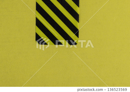 a closed yellow package with a protective sticker against opening and theft, a whole striped sticker to protect the goods from opening a closed yellow package with a protective sticker against opening and theft, a whole striped sticker to protect the goods from opening 136523569