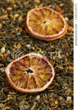 high-quality green tea with added pieces of fruit and cut dried red oranges, bright large dry slices of blood red orange and green tea with pieces of fruit 136523573