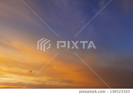 Beautiful multi-colored sunset with different colors and clouds as the sun sets over the horizon, sunset or sunrise Beautiful multi-colored sunset with different colors and clouds as the sun sets over the horizon, sunset or sunrise 136523583