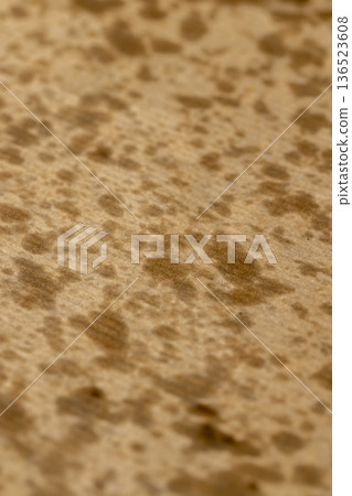 sunflower oil stains on packaging paper after the paper contained crispy potato chips that were deep fried 136523608