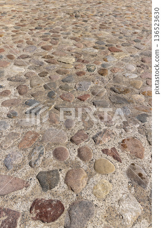 one road made of stones of different sizes in rural areas, a reconstructed ancient road made of multicolored stones, cobblestones and pebbles one road made of stones of different sizes in rural areas, a reconstructed ancient road made of multicolored stones, cobblestones and pebbles 136523630