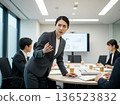 A Japanese woman in a business suit talking with a serious expression in an office conference room. Work, career, consultation 136523832