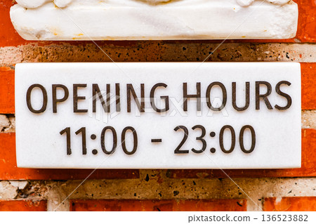opening hours of establishments on marble plaque from 11 till 23 opening hours of establishments on marble plaque from 11 till 23 136523882