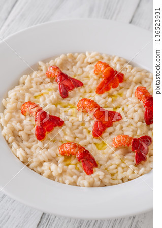 Creamy Italian risotto topped with crawfish tails and olive oil, bright gourmet styling Creamy Italian risotto topped with crawfish tails and olive oil, bright gourmet styling 136523931