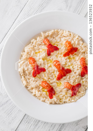 Creamy Italian risotto topped with crawfish tails and olive oil, bright gourmet styling Creamy Italian risotto topped with crawfish tails and olive oil, bright gourmet styling 136523932
