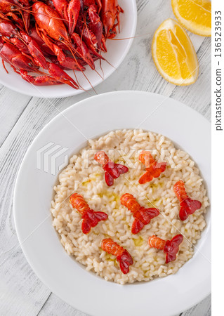 Creamy Italian risotto topped with crawfish tails and olive oil, bright gourmet styling 136523933