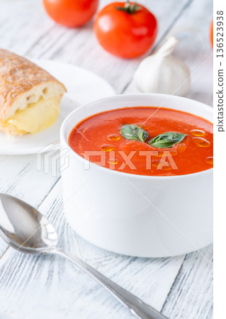 Classic tomato soup served with grilled cheese sandwich on bright rustic table Classic tomato soup served with grilled cheese sandwich on bright rustic table 136523938
