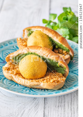 Vada Pav Indian street food served on blue plate in bright overhead composition Vada Pav Indian street food served on blue plate in bright overhead composition 136523947