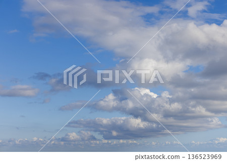 Blue sky cloudscape for design and sky replacement, with layered cumulus and stratocumulus drifting 136523969