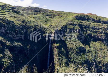 Garganta Funda cascade at Ponta do Pargo, Madeira, a narrow stream drops into a shadowed ravine 136523972