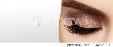 Beautiful macro shot of female eye with extreme long eyelashes and black liner makeup. Perfect shape make-up and long lashes. Cosmetics and make-up. Closeup macro shot of fashion eyes visage Beautiful macro shot of female eye with extreme long eyelashes and black liner makeup. Perfect shape make-up and long lashes. Cosmetics and make-up. Closeup macro shot of fashion eyes visage 136524083