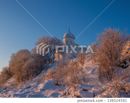 Beautiful church is in the background of a snowy landscape.. Beautiful church is in the background of a snowy landscape.. 136524581