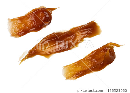 Caramel dessert sauce splattering drips on transparent background 136525960
